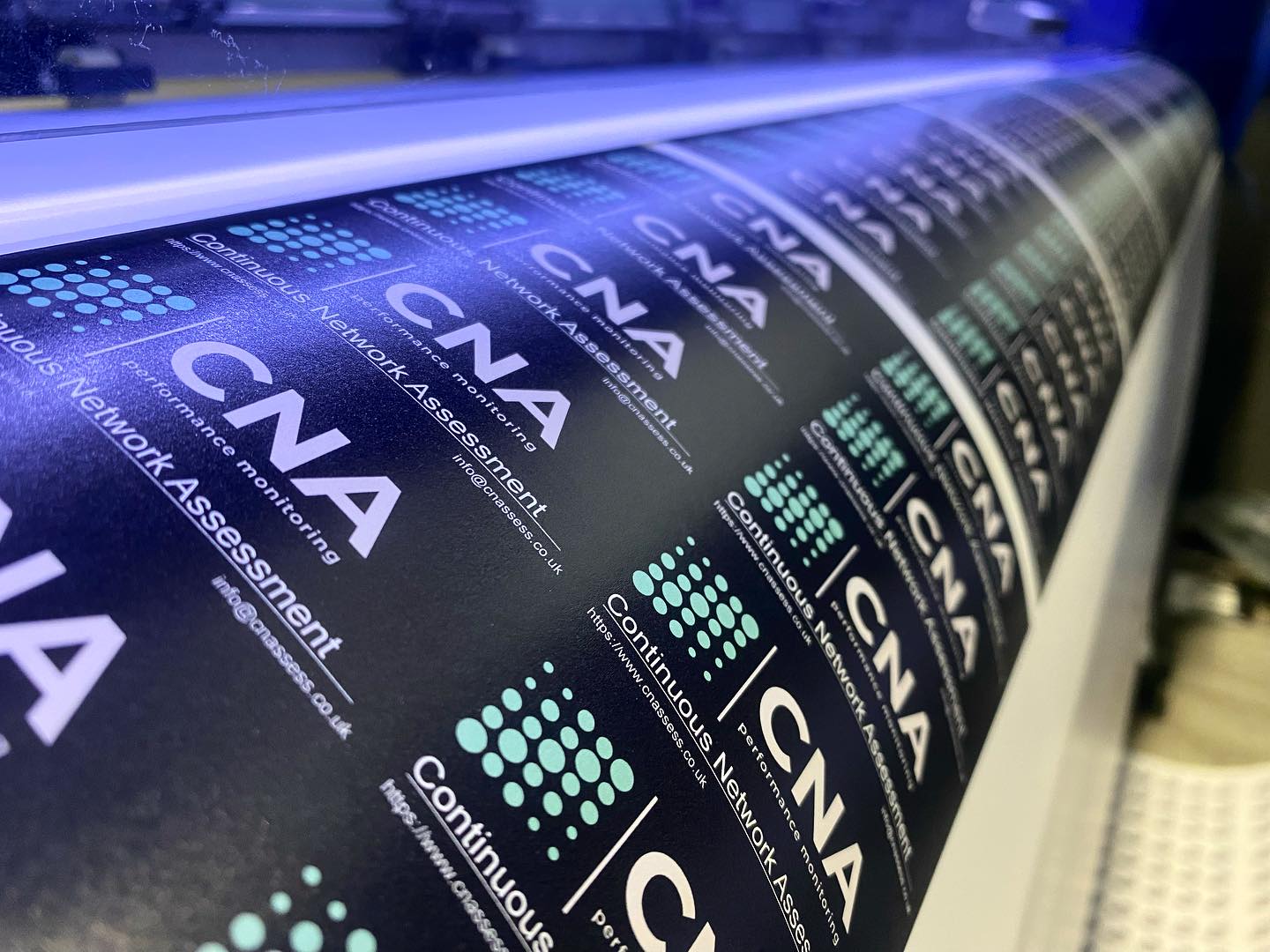 Dark matte branded vinyl labels being printed on press – waterproof non-glare stickers