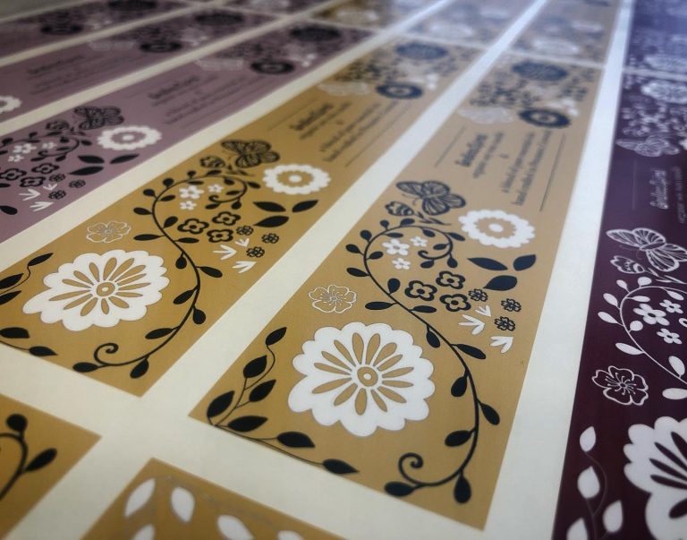 Custom matte vinyl candle labels with floral branding – multi-shade designs, waterproof non-glare stickers