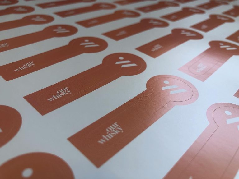 Custom shaped matte vinyl labels with flat solid orange print – waterproof non-glare stickers
