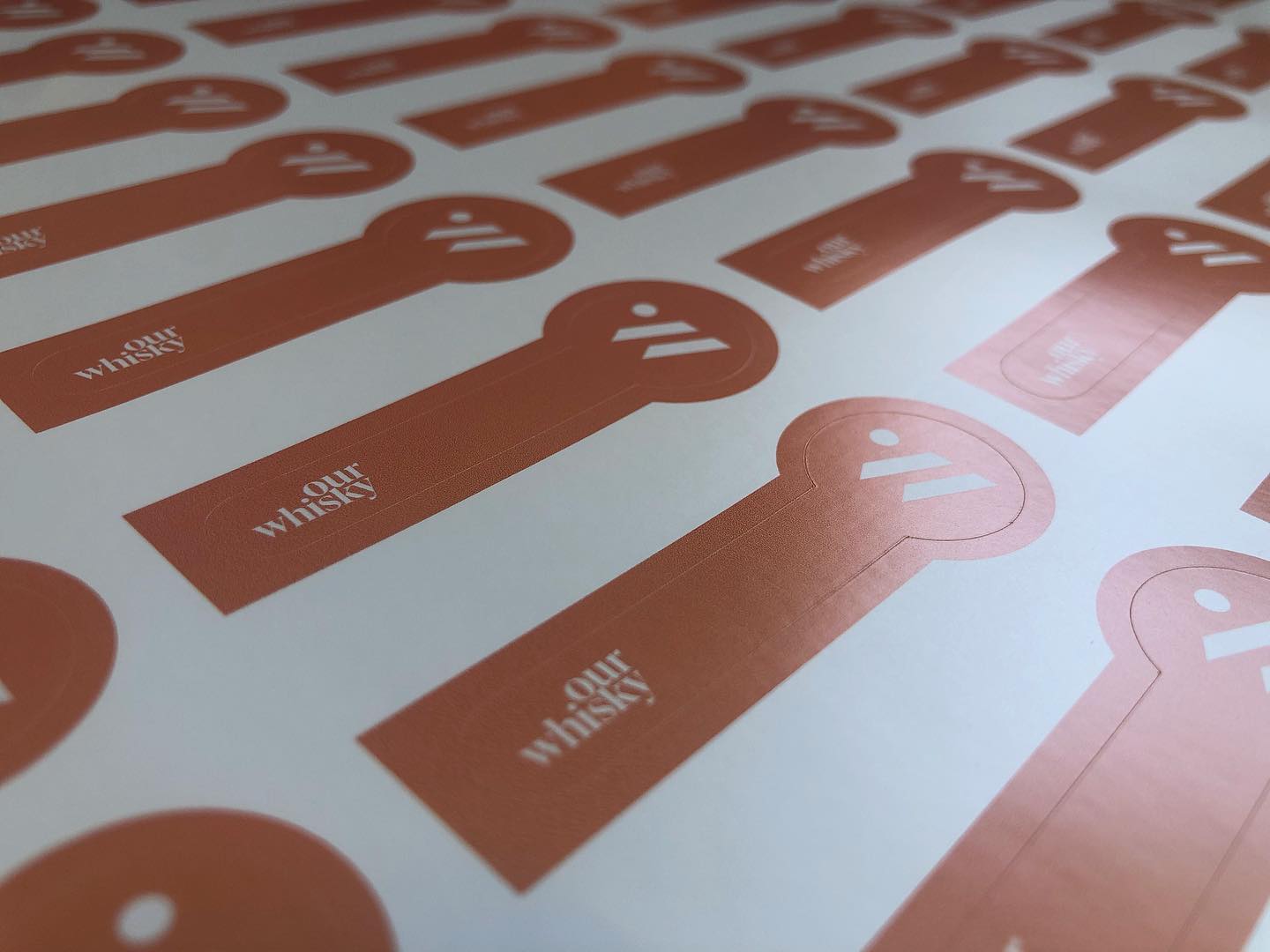 Custom shaped matte vinyl labels with flat solid orange print – waterproof non-glare stickers