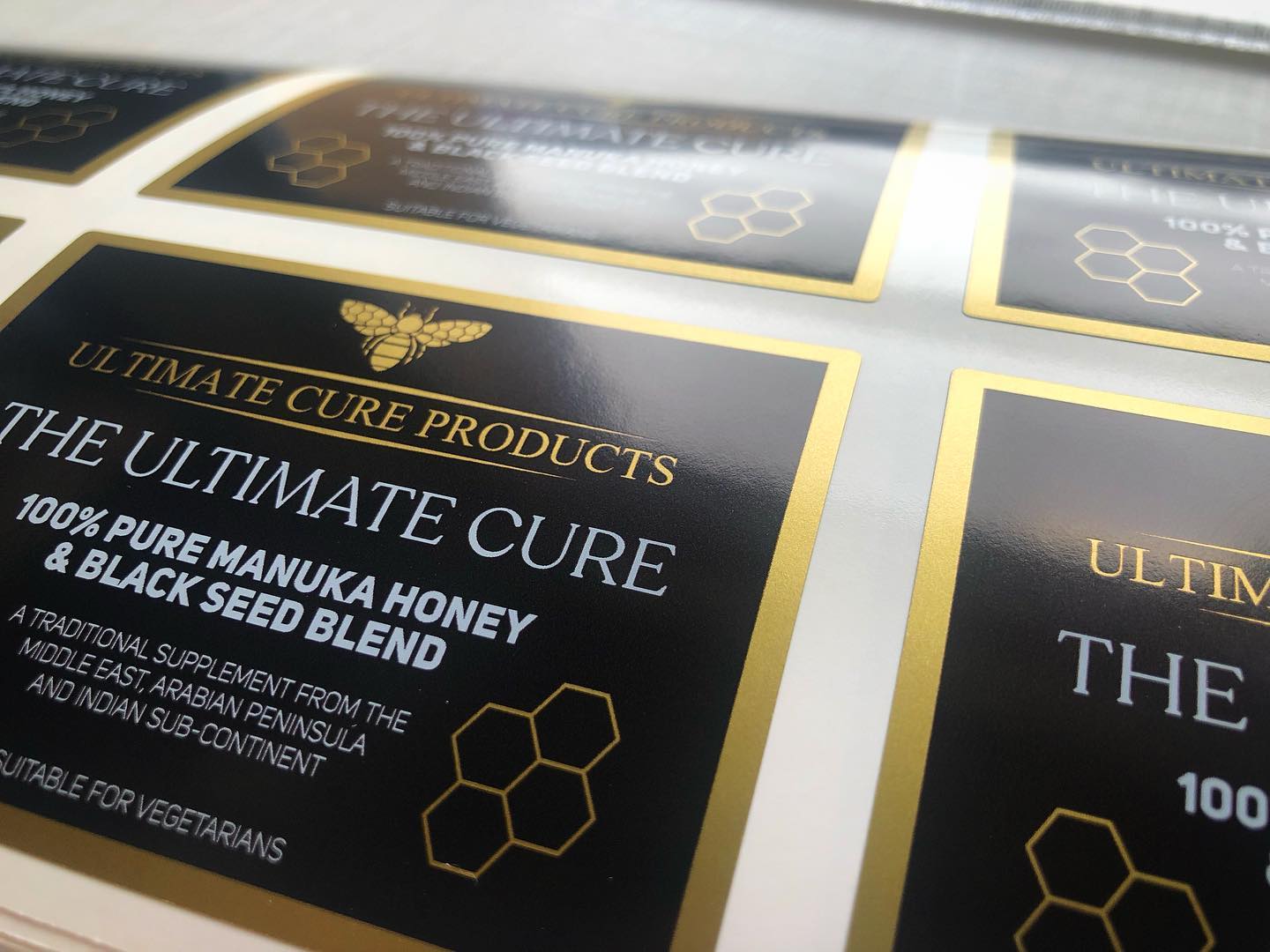 Custom satin gold vinyl candle labels with black and gold branding – luxury waterproof stickers