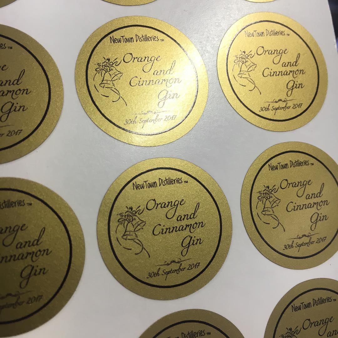 Custom round satin gold vinyl gin labels with monochromatic print – luxury branded stickers