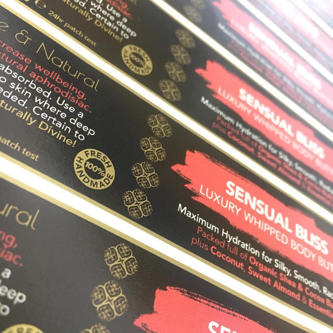 Custom satin gold vinyl labels in black, gold, red and white – luxury multi-colour waterproof stickers