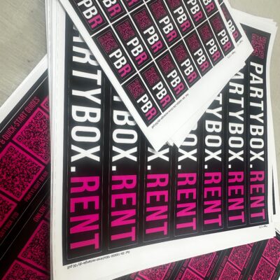 Glossy vinyl labels in multiple shapes and sizes. Deep black glossy labels with a bright magenta detail. — Waterproof Stickers with a Glossy Finish